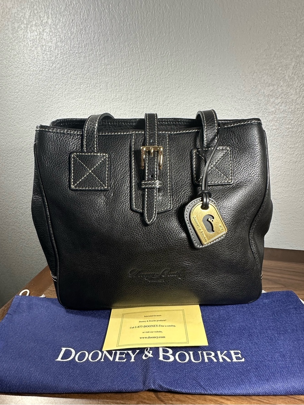 Dooney & Bourke Black Leather Tote with Gold Buckle Accent